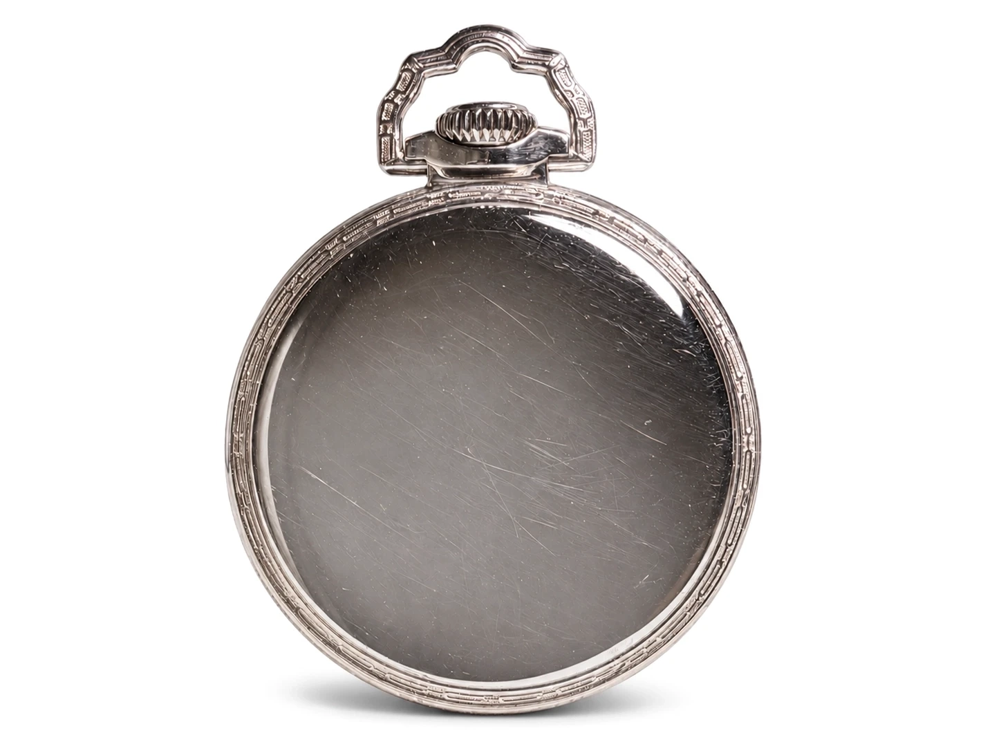 Closed white gold pocket watch case back with ornate bail and visible wear scratches.