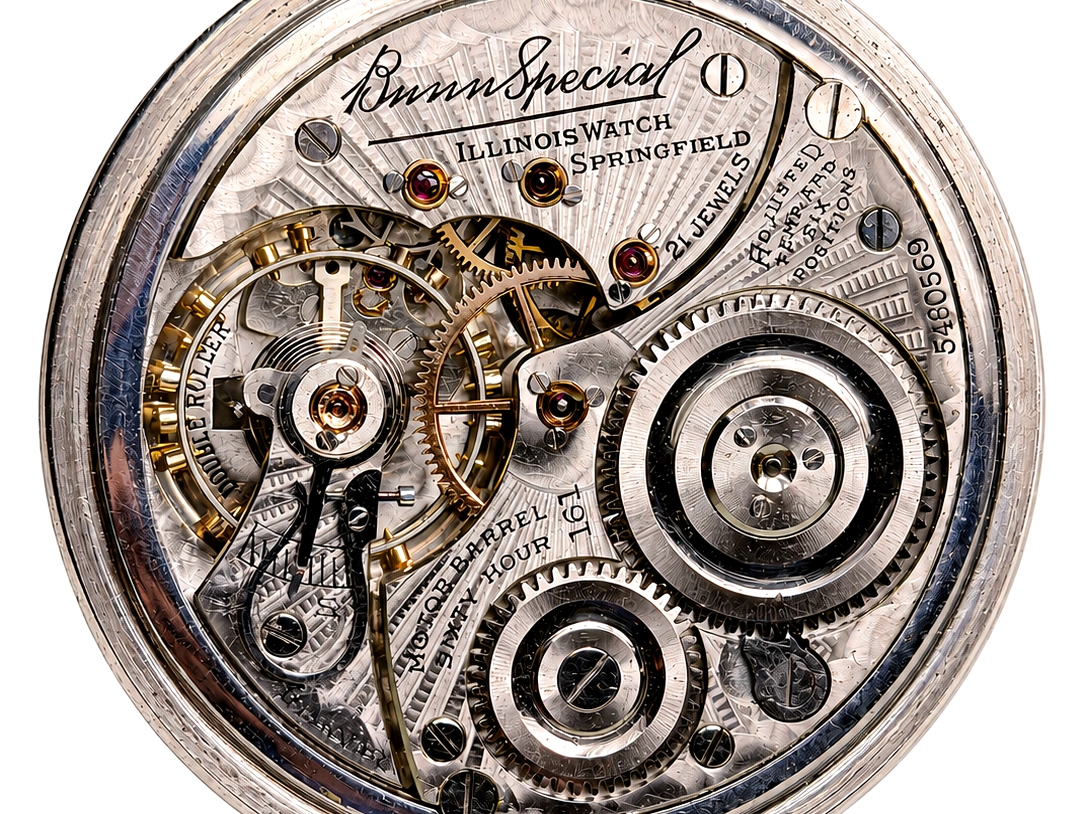 Open pocket watch movement showing brass gears, jeweled bearings, and Illinois Watch Company Springfield markings.