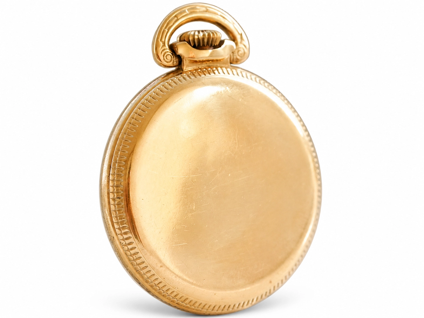 Back of a gold pocket watch case with decorative beaded border and rope-twist bail.