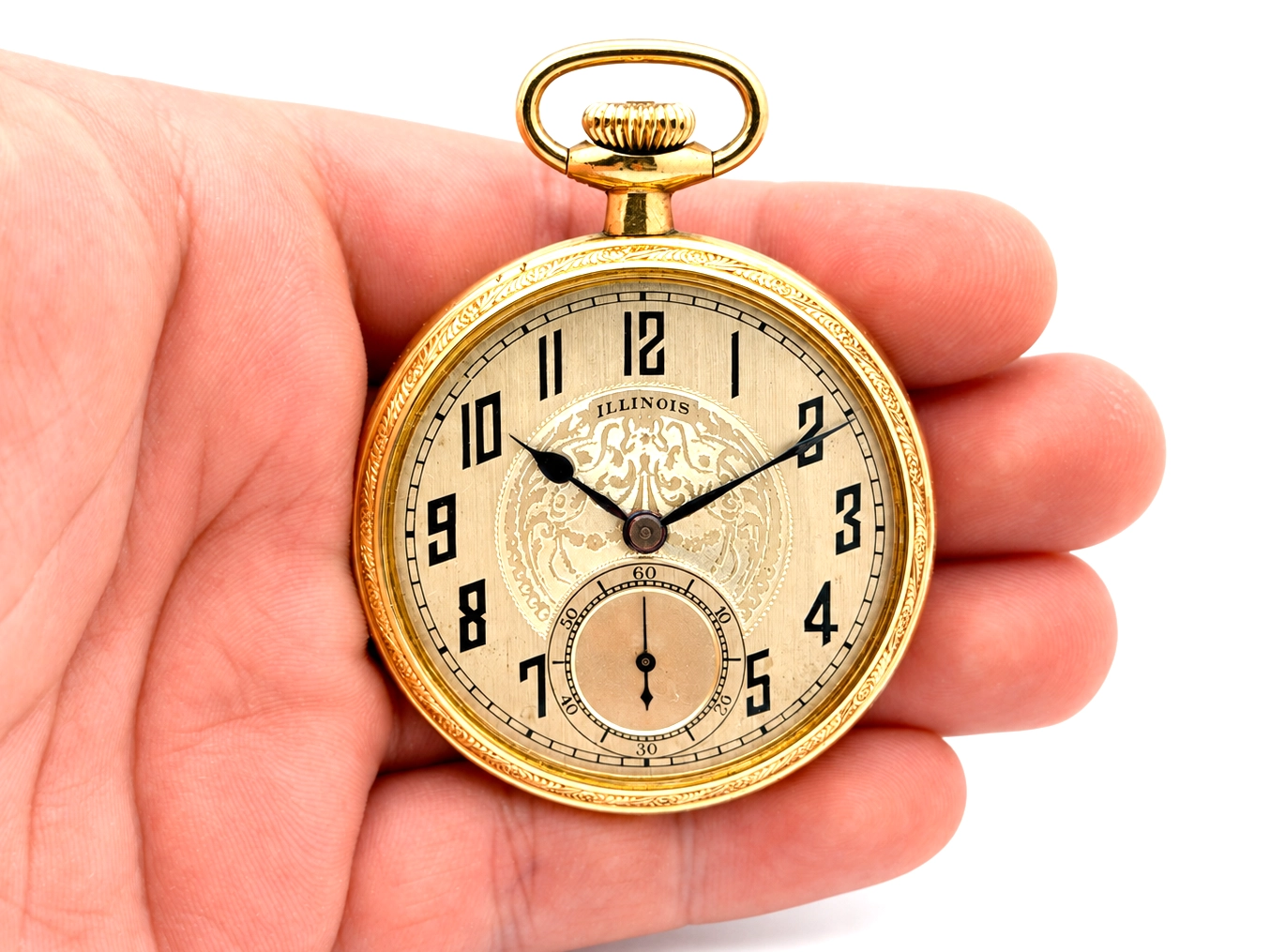 Illinois Dress 605 (1921) — closed yellow case front with Arabic numerals, decorated dial center, and small subsidiary seconds dial at 6…