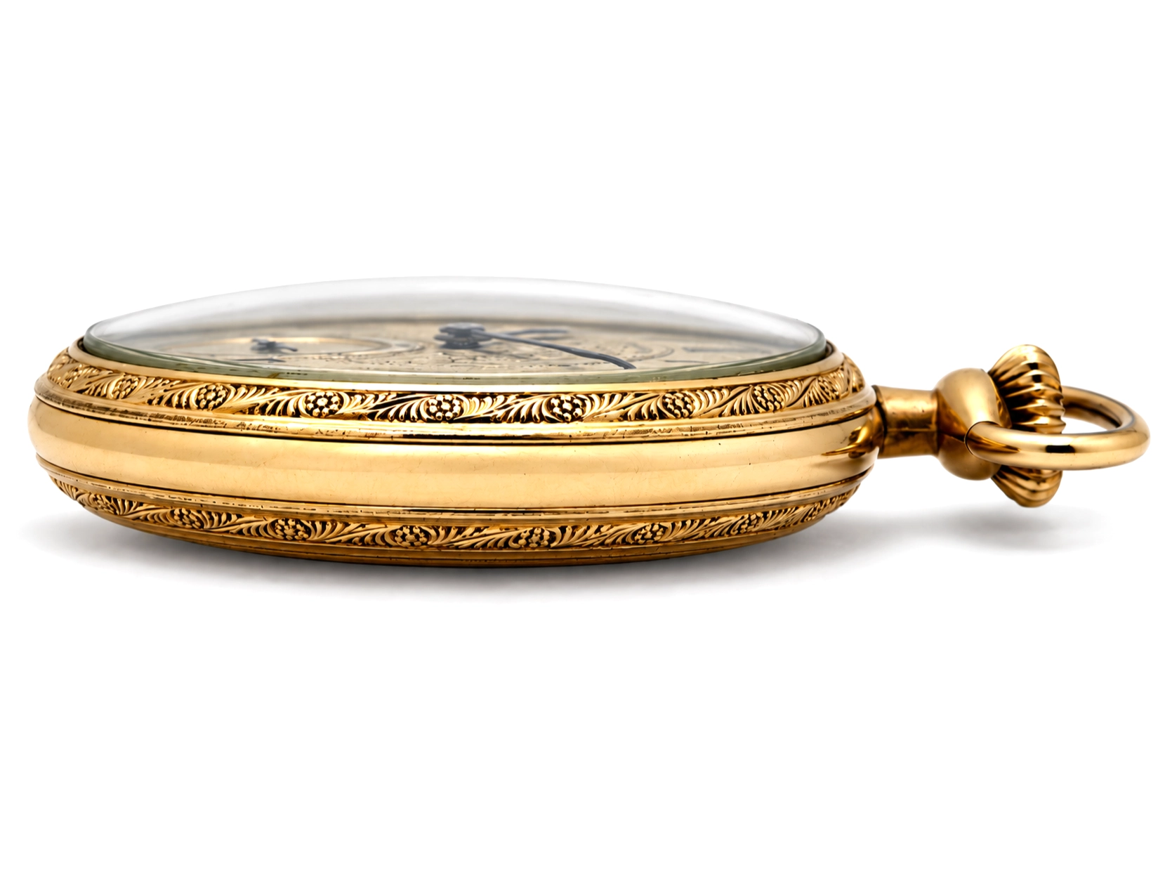 Illinois Dress 605 (1921) — closed yellow case with ornate engraved shell and geometric bands, polished domed bezel, floral-decorated…