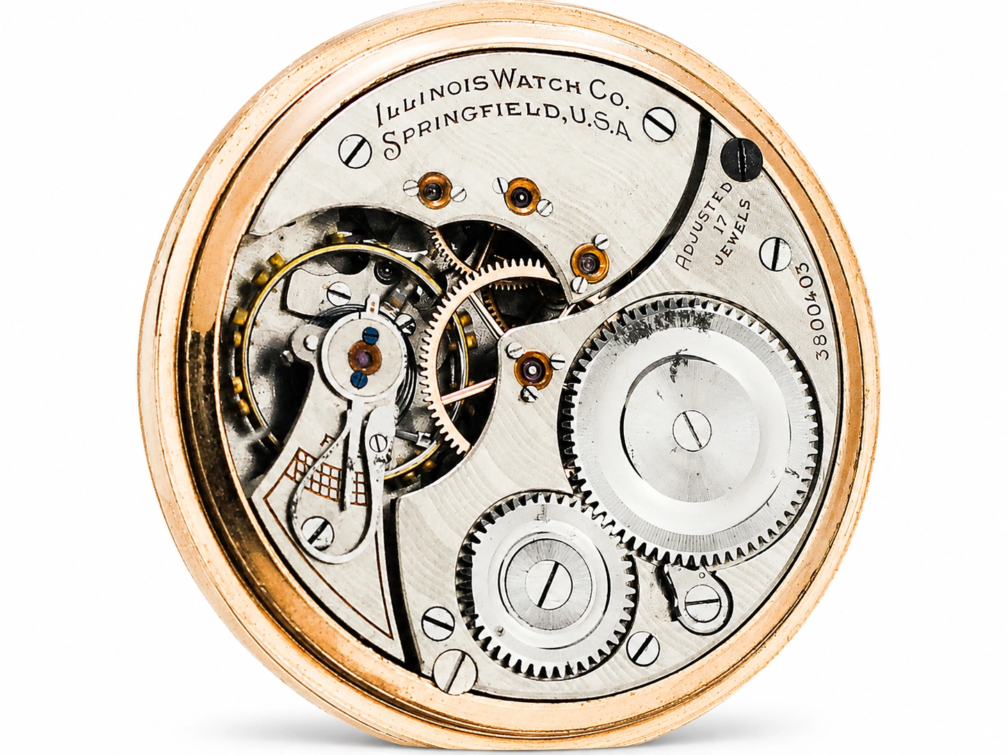 Open movement showing gear train, balance wheel, and jeweled lever escapement in gold-filled case.