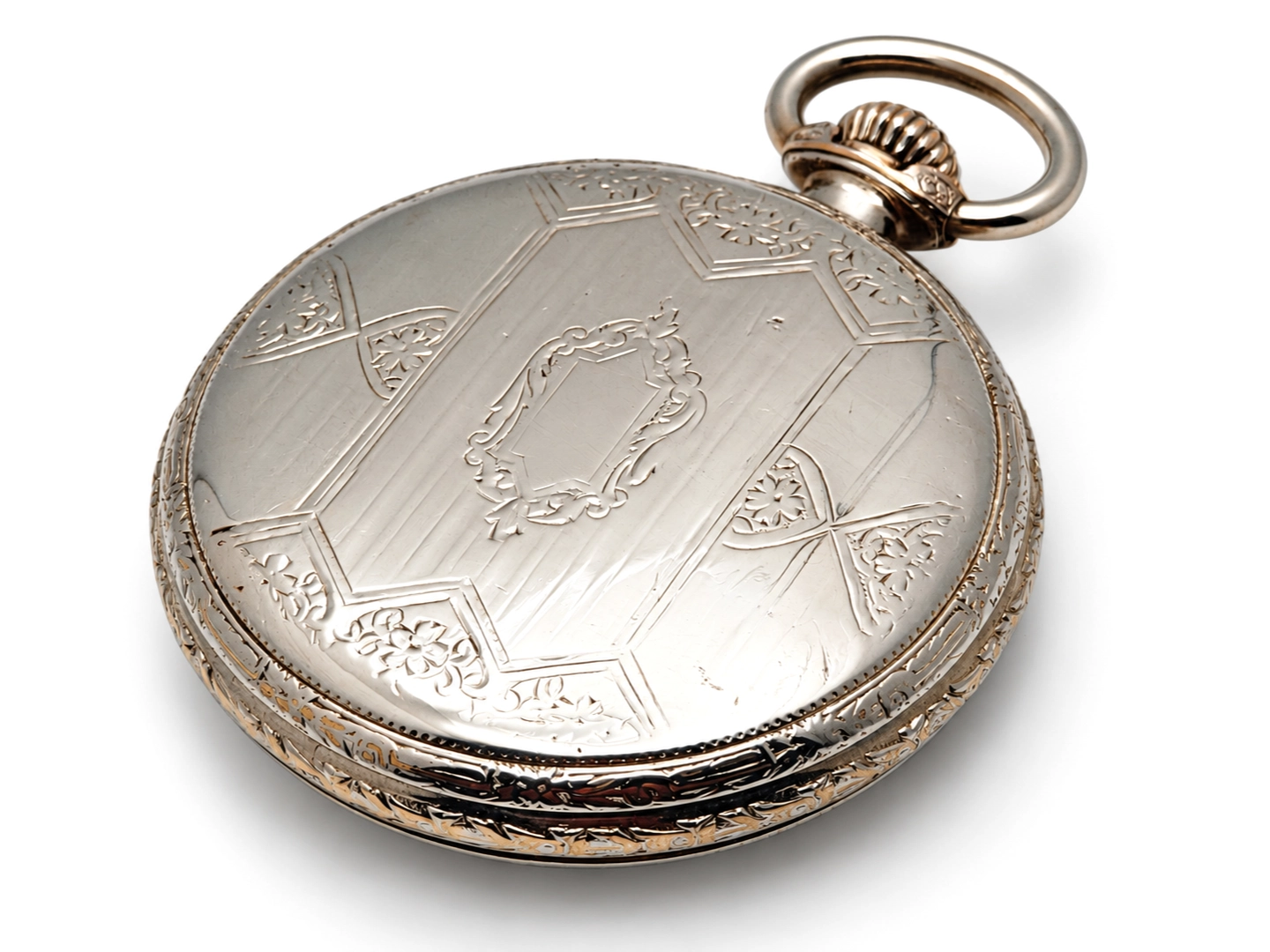 Illinois A. Lincoln White GF Wadsworth Case (1917) — closed case back with engraved shield cartouche, geometric panels, and ornamental…