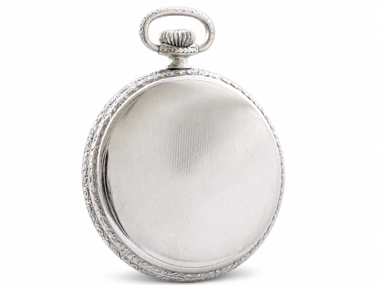 Silver pocket watch with ornate beaded edge case and fluted crown, shown closed.