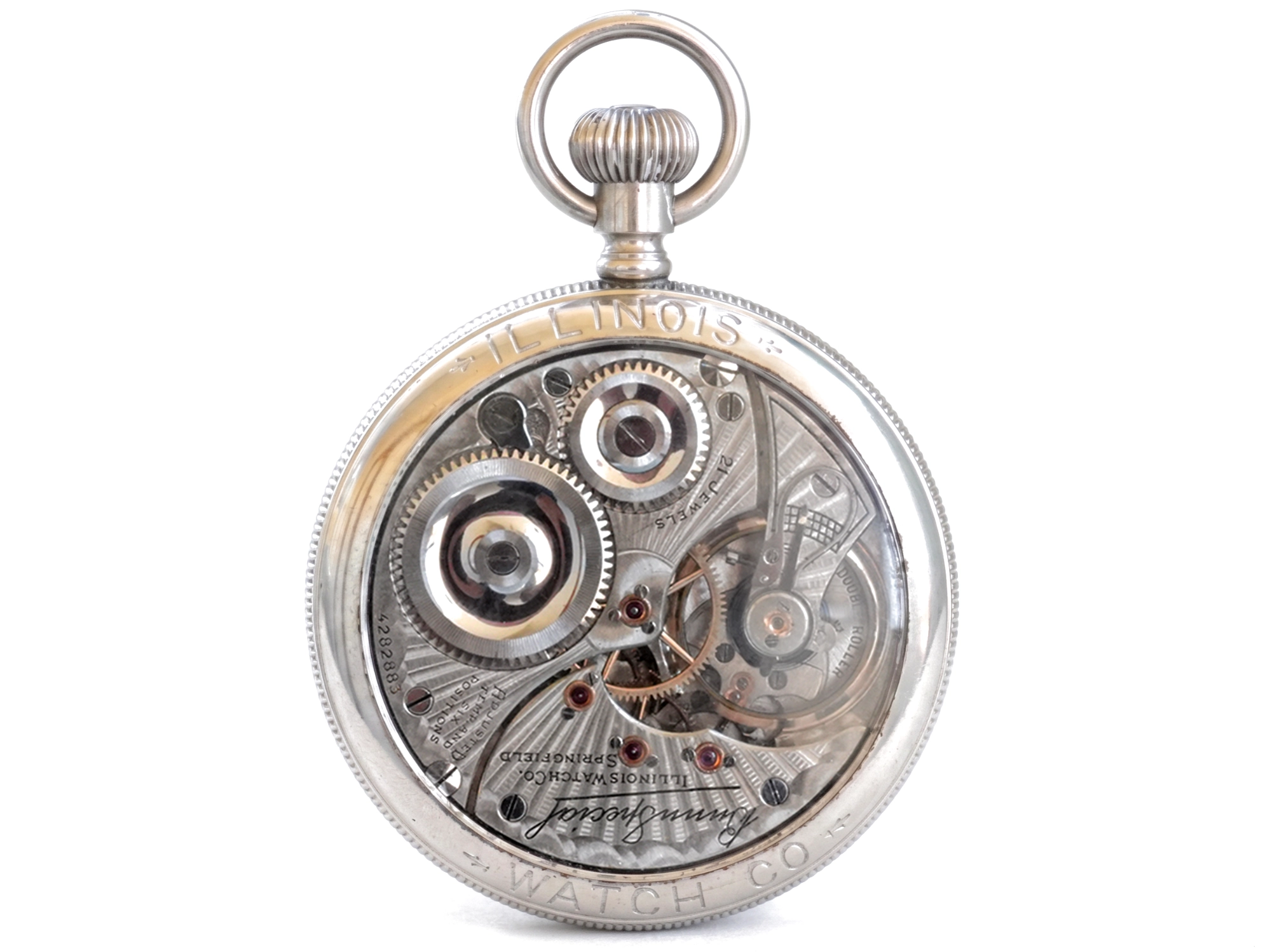 Open pocket watch movement with exposed gears, jewels, and balance wheel visible through transparent case back.