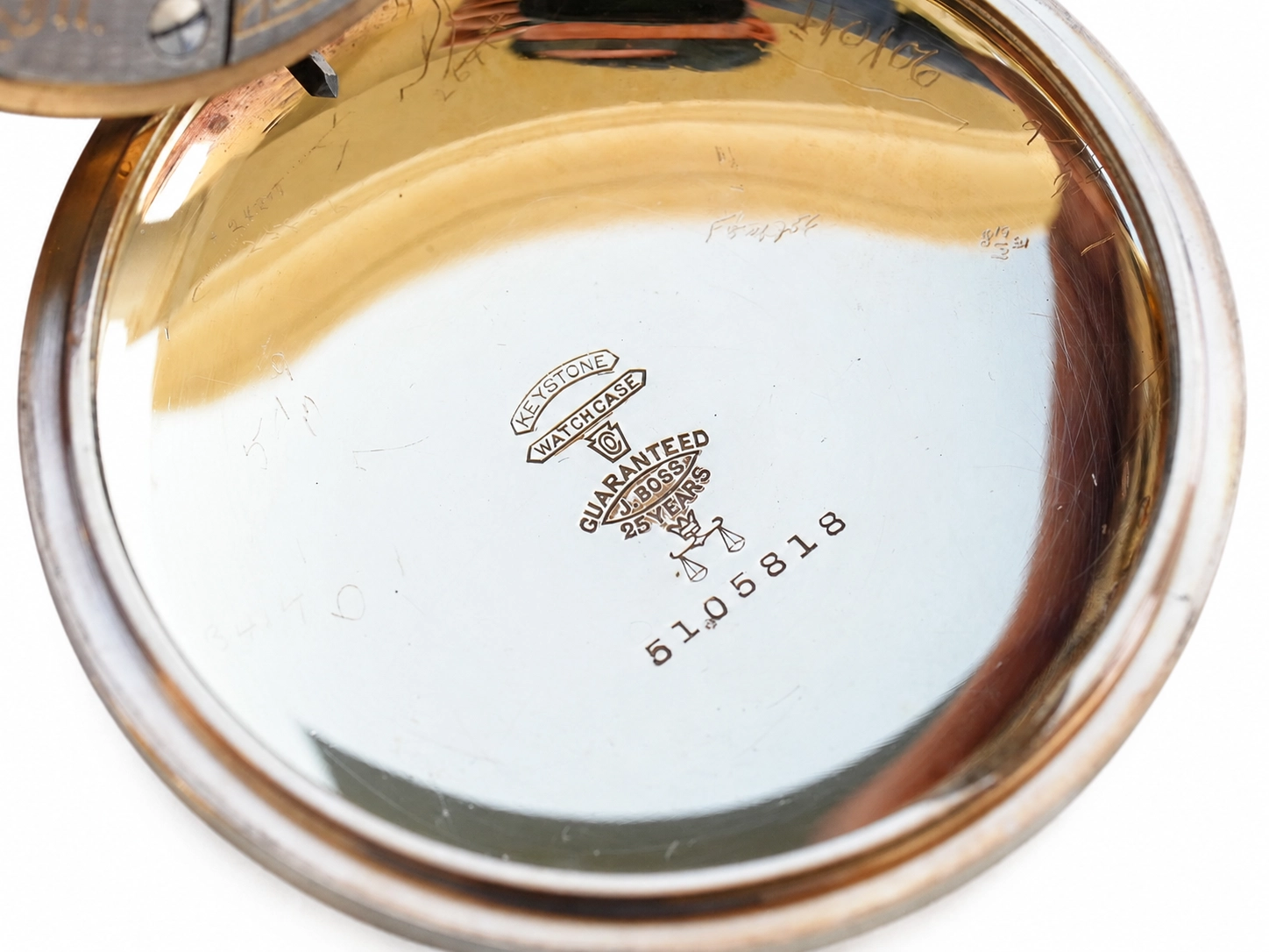 Gold case back with engraved hallmarks, manufacturer stamps, and serial number 5180S118.