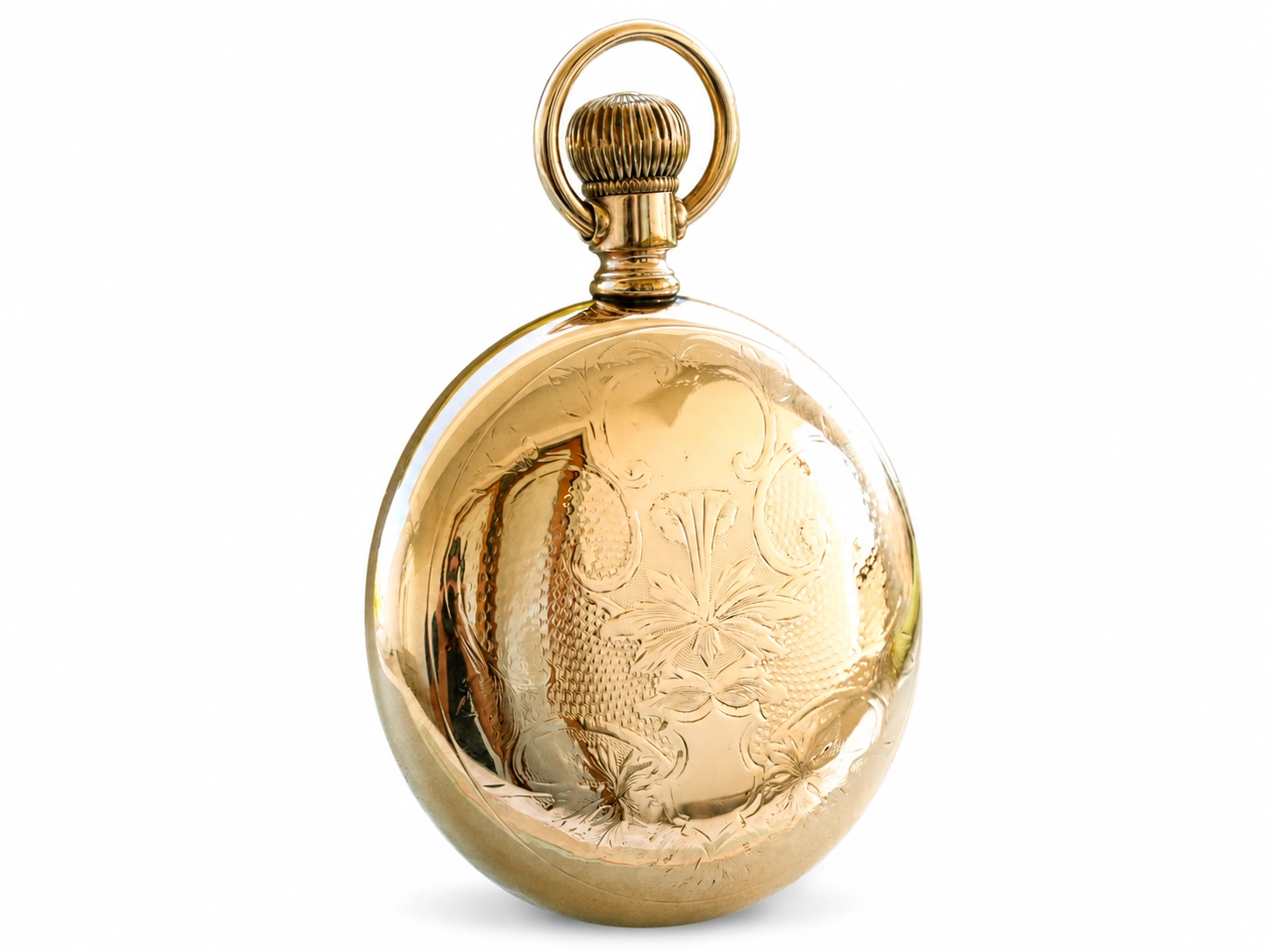 Gold pocket watch with ornate floral engraving and ribbed crown loop, shown from back.