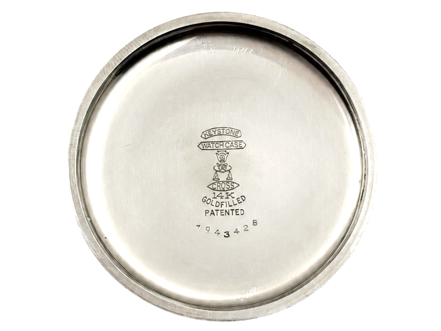 Polished metal case back engraved with Keystone watchcase hallmarks and patent markings.