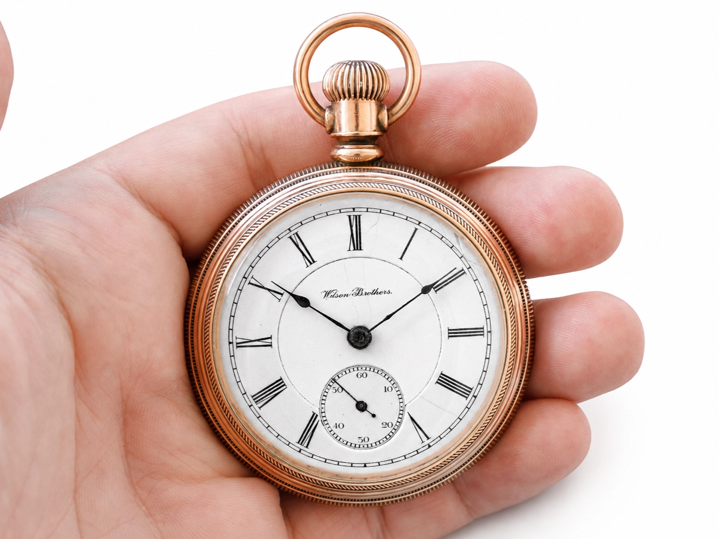 Rose gold pocket watch with white dial, Roman numerals, black hands, and subsidiary seconds dial.