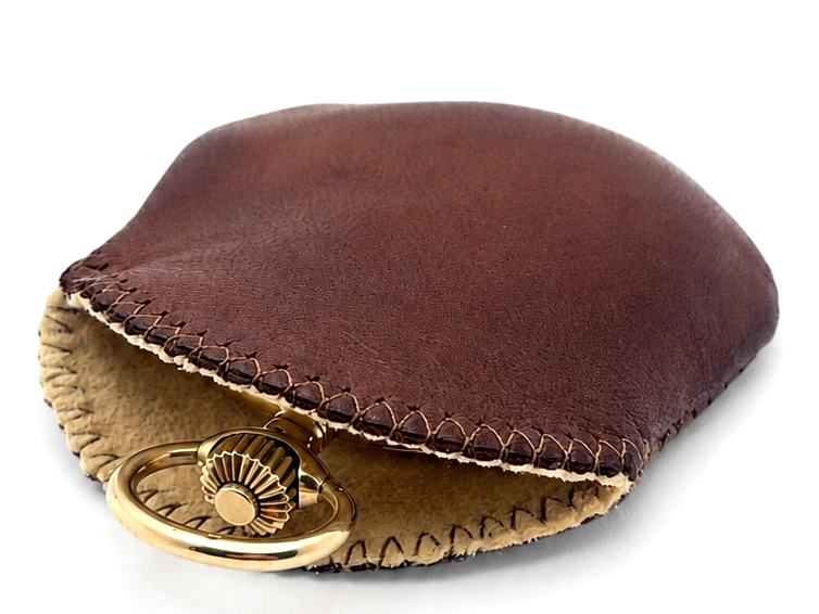 Brown and tan leather watch pouch with brass decorative clasp closure.