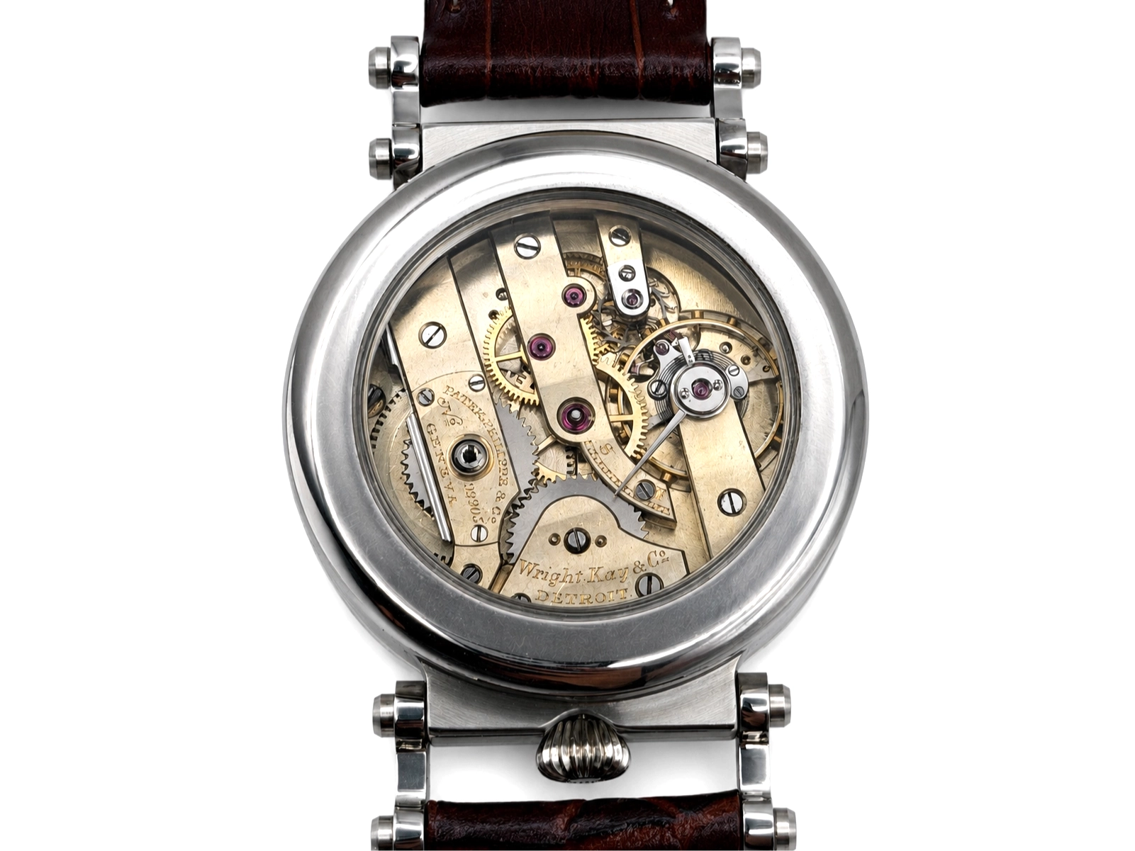 Transparent caseback revealing visible movement with brass plates, jeweled bearings, and exposed gears.
