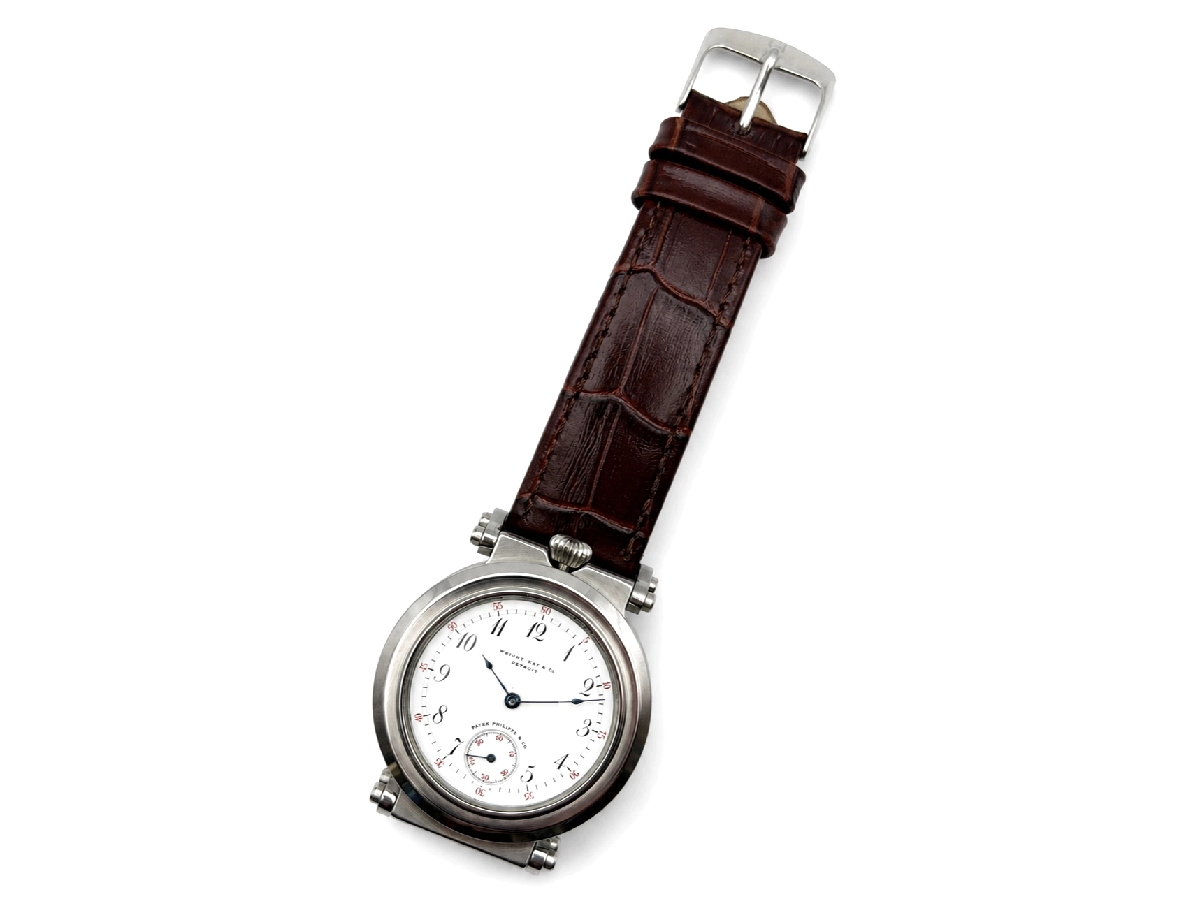 Pocket watch with white dial, Arabic numerals, subsidiary seconds dial, silver case, and dark brown crocodile leather strap.