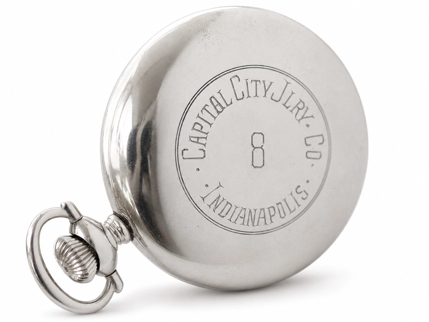 Silver case back engraved with circular text reading "Capital City Jewelry Co., Indianapolis" and number 8.