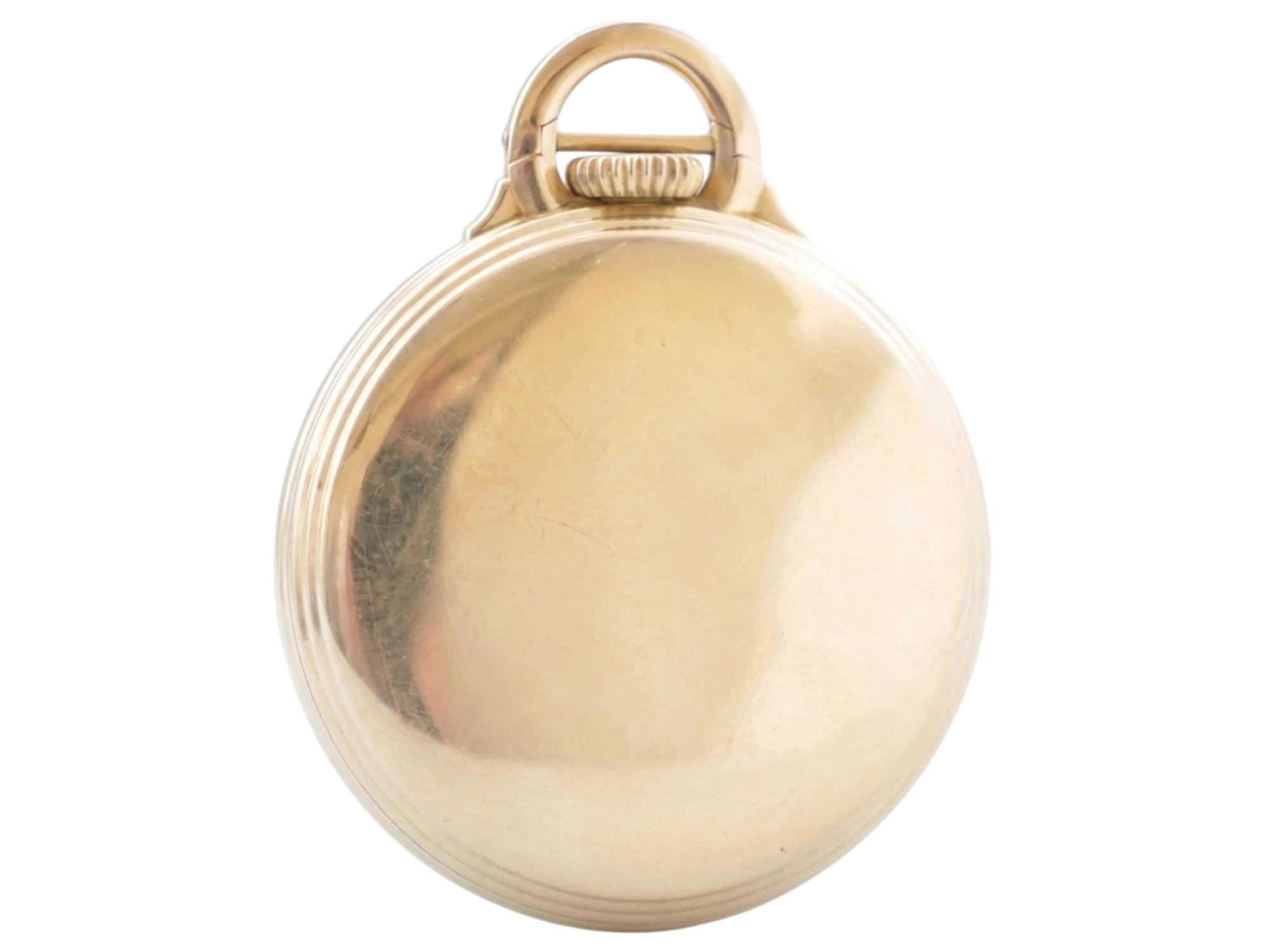 Polished yellow gold case back with ribbed bail and subtle wear marks visible on surface.