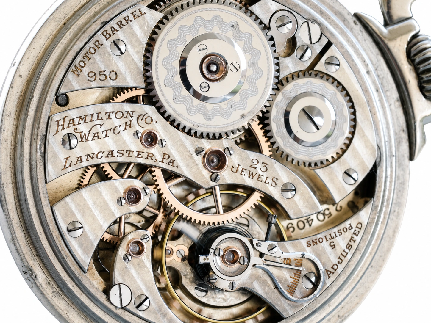 Open movement showing jeweled balance wheel, gears, and Hamilton Watch Company Lancaster PA engraving.