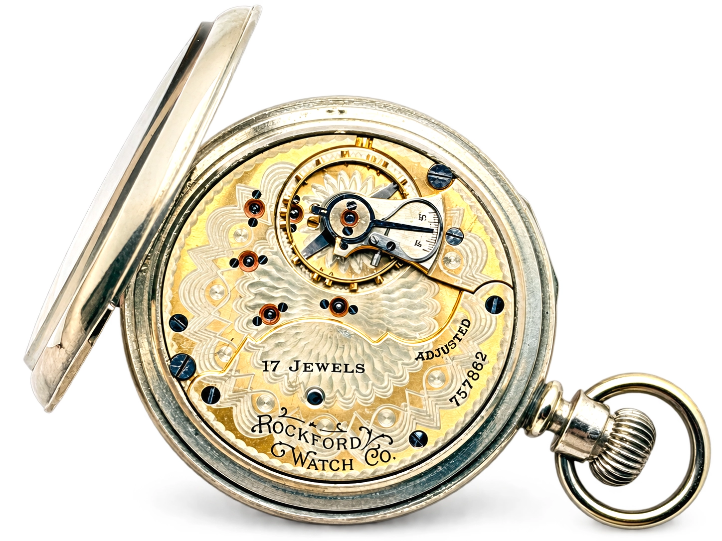 Rockford Grade 925 Hinged Display — open movement showing decorated balance wheel, jeweled screwless regulator, and ornamental…