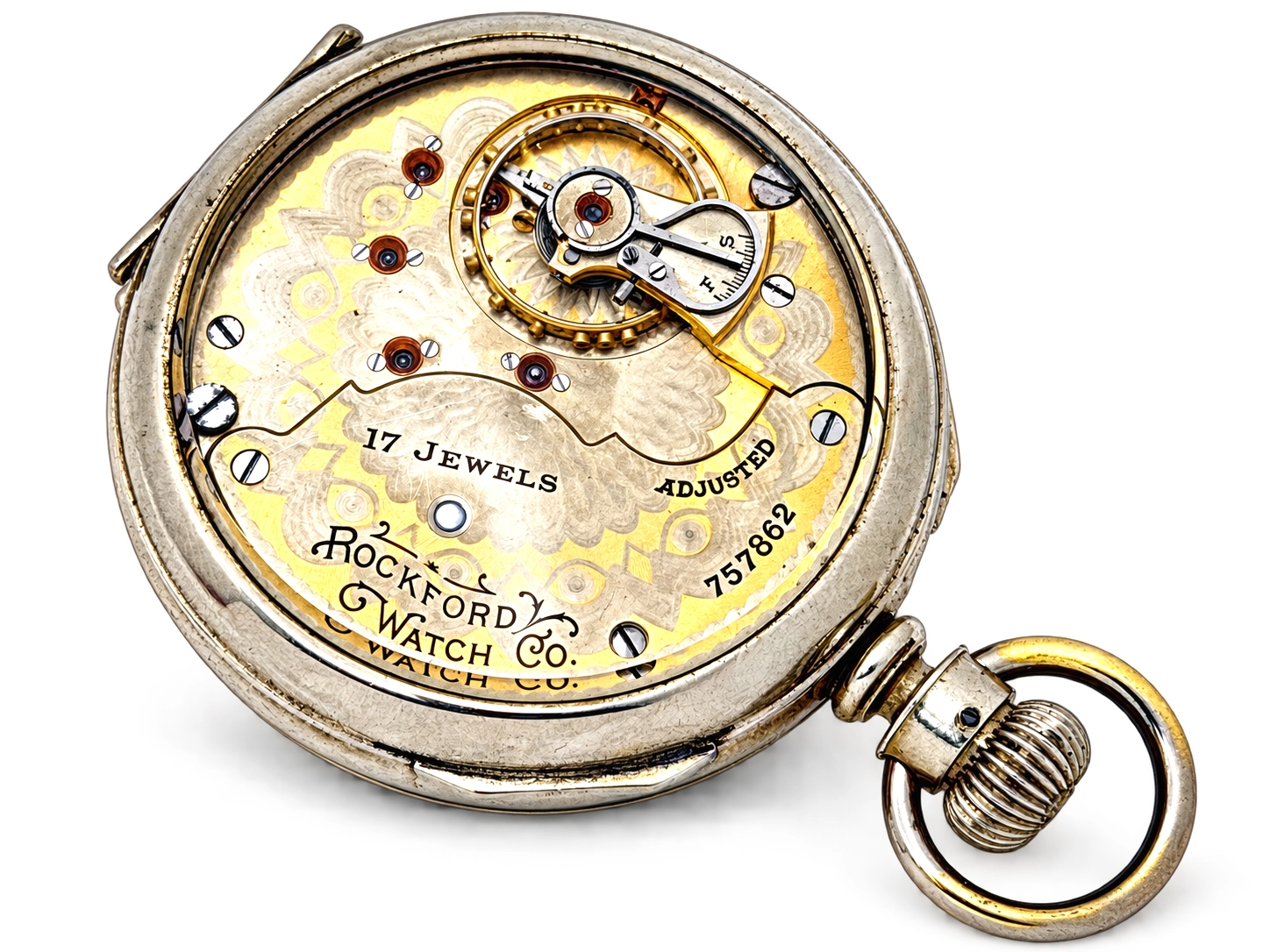 Rockford Grade 925 Hinged Salesman Display — open movement with decorated wheels, red jewels, balance staff, and engraved plate marked "17…