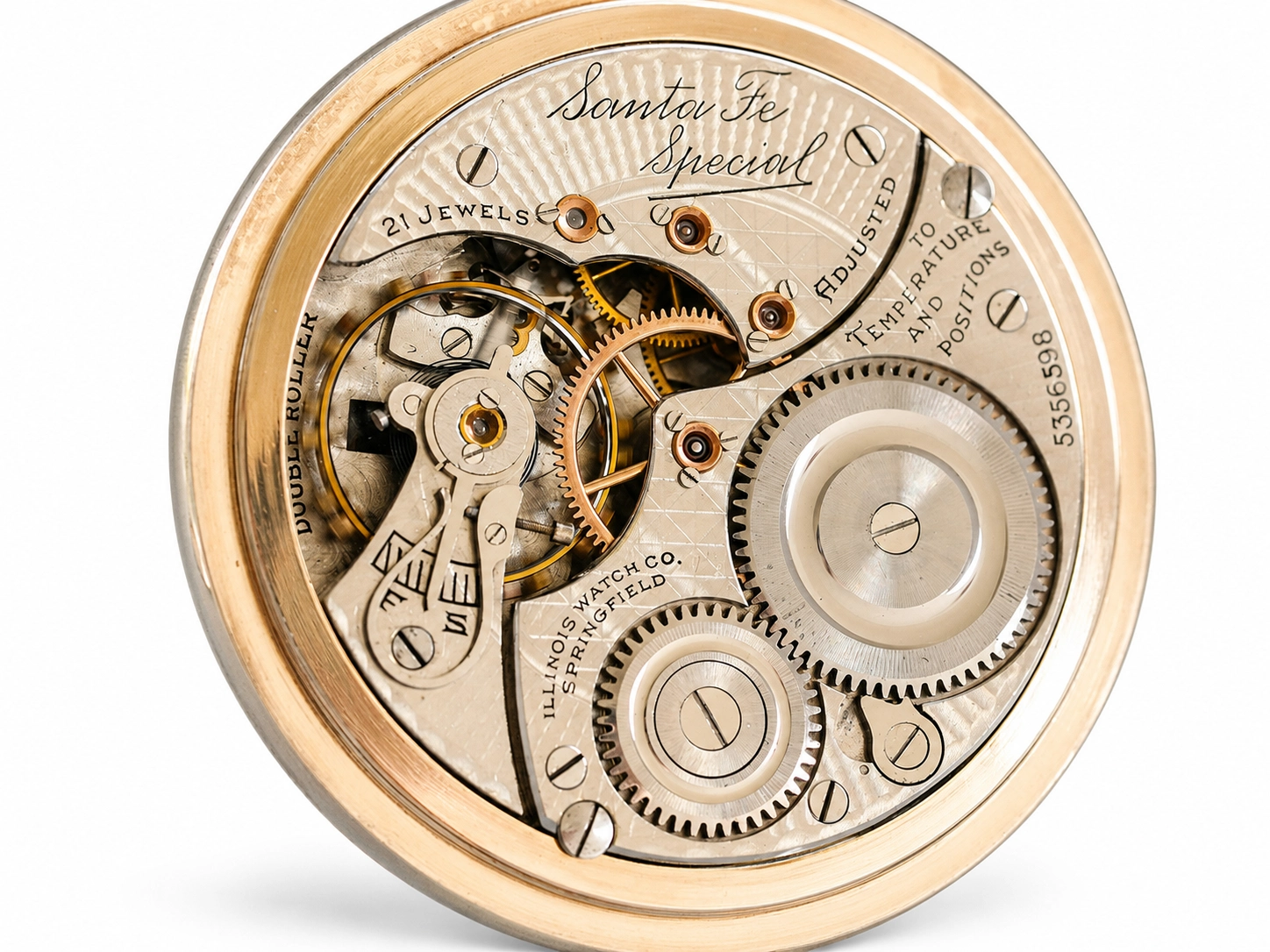 Open pocket watch movement showing 21 jewels, balance wheel, gears, and Illinois Watch Co markings.