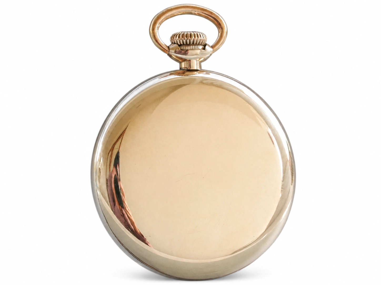 Smooth polished case back of a gold pocket watch with curved bail loop on top.