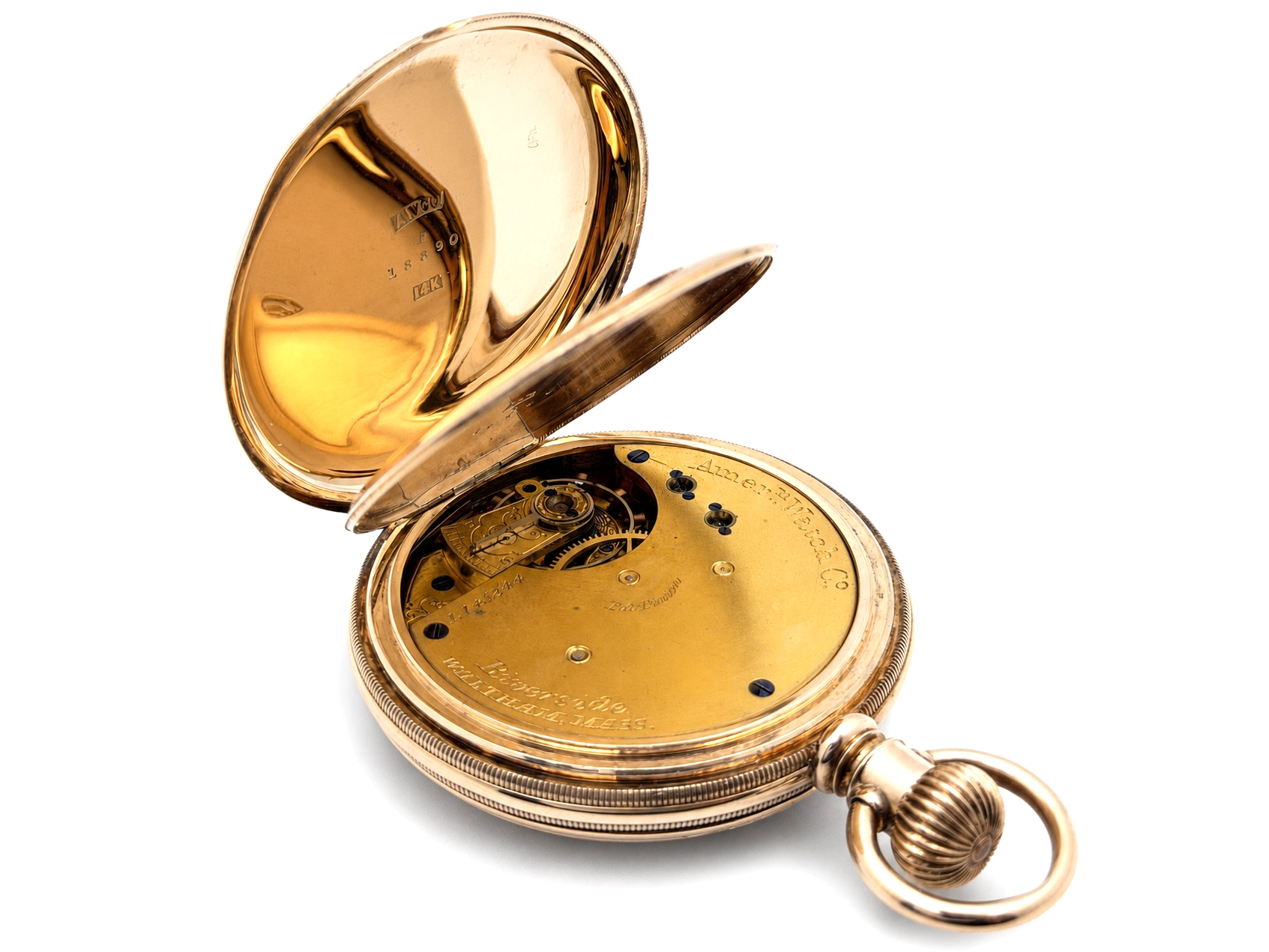 Open pocket watch showing gilt movement with black jewel settings and exposed balance wheel.