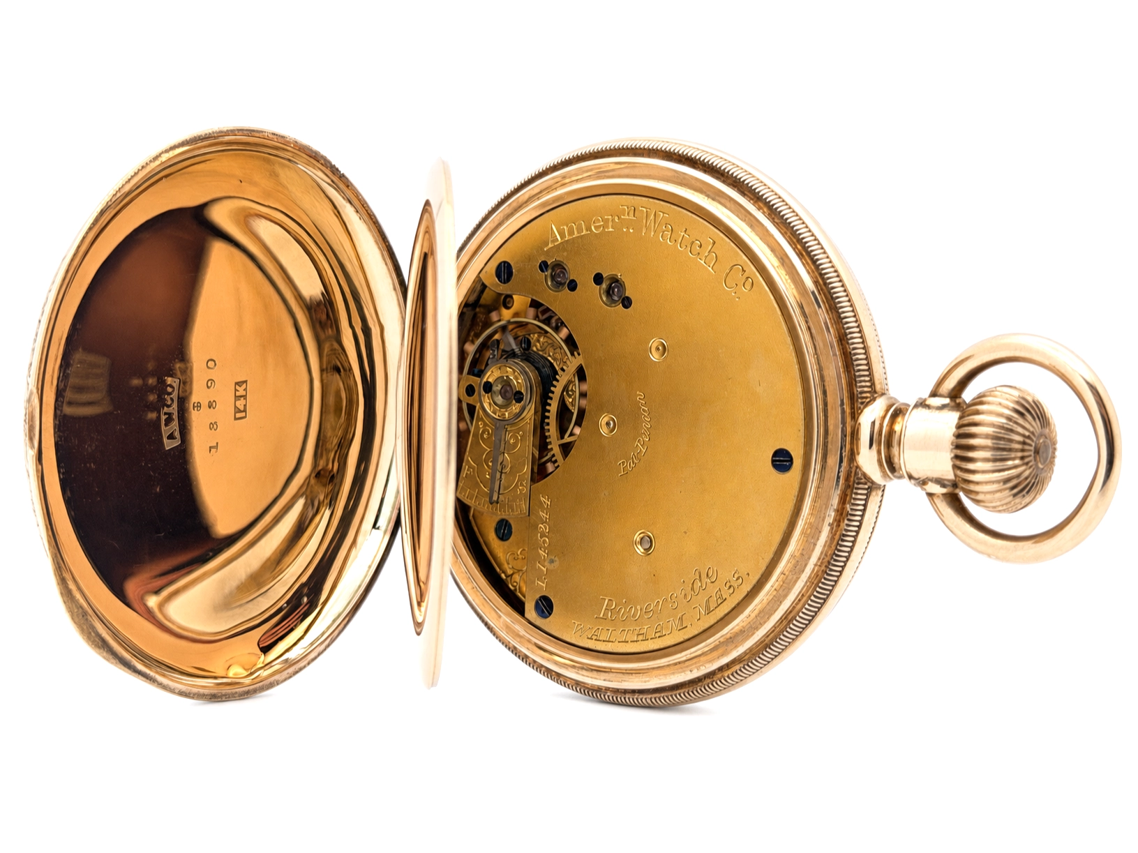 Open gold pocket watch showing exposed movement with jewels and engraved caseback.