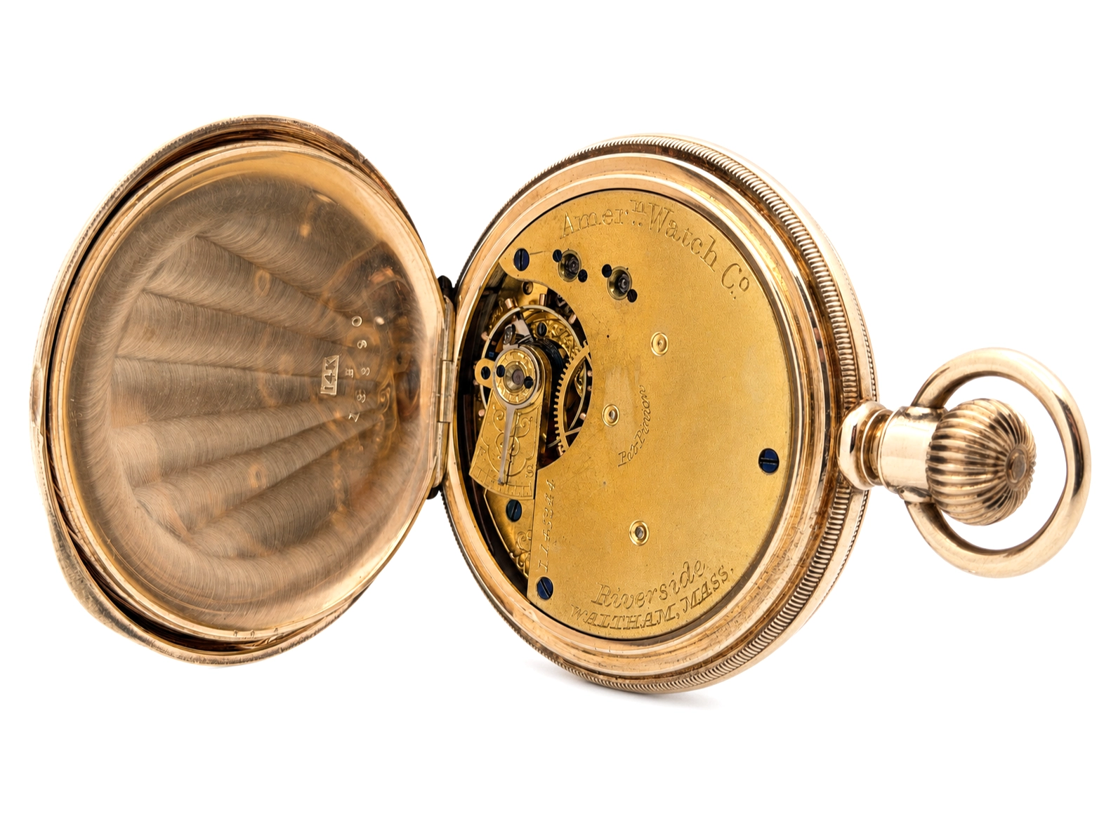Open pocket watch case exposing brass movement with jewels and engraved plate visible.