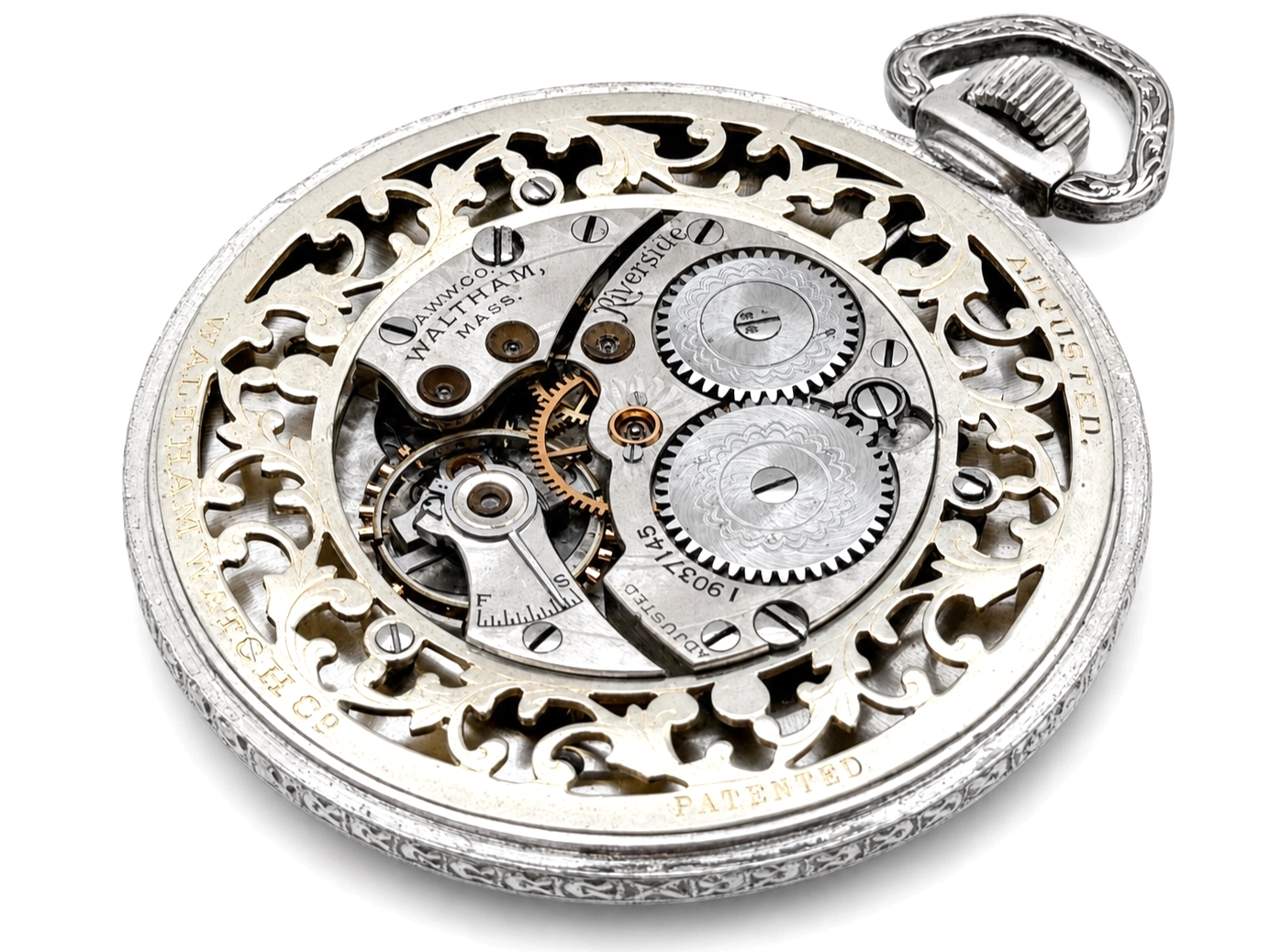 Open caseback revealing ornate filigree design with exposed brass and steel gears and jeweled movement.