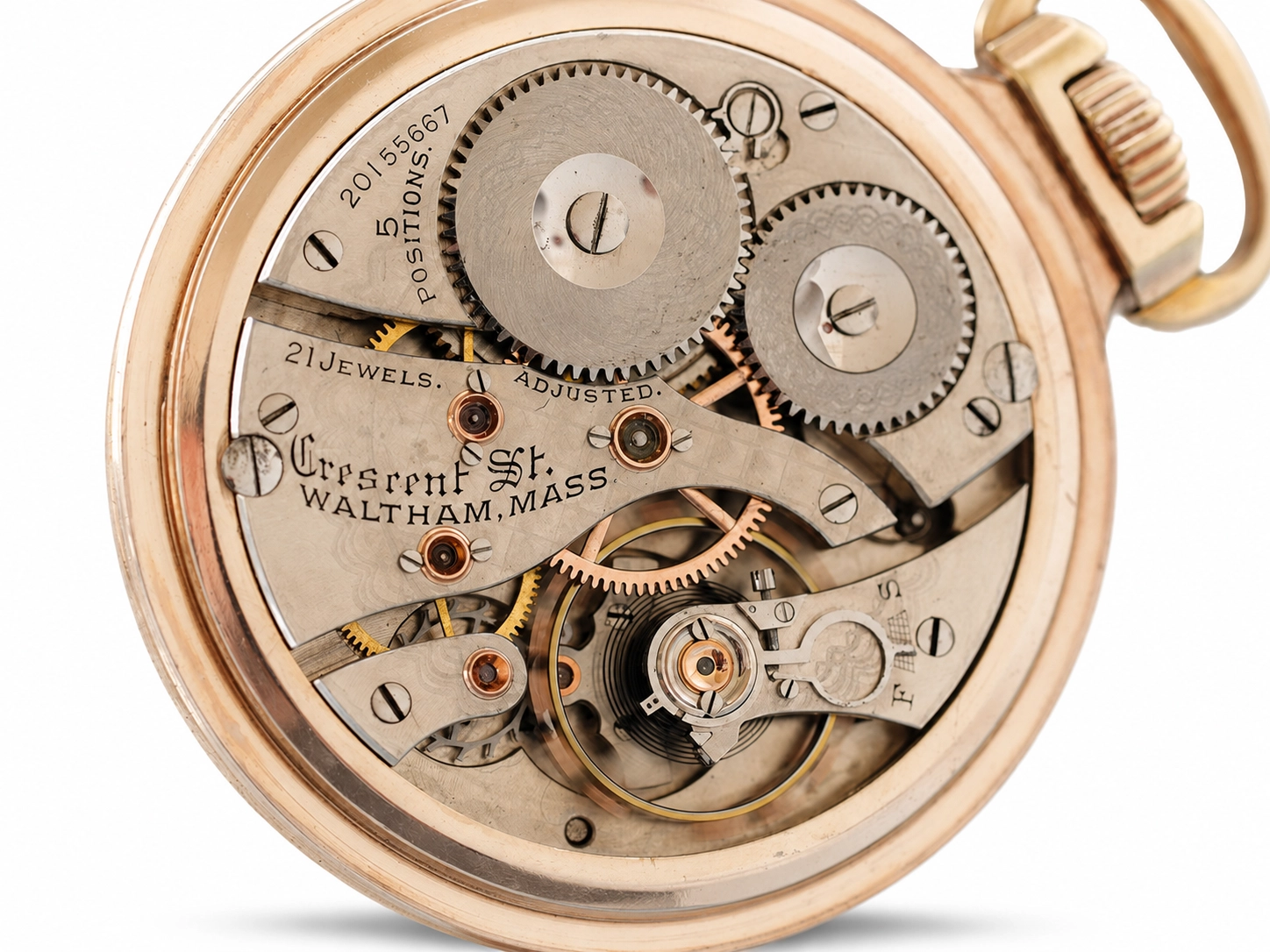 Open pocket watch movement showing 21 jewels, dual gear wheels, balance wheel, and Waltham Mass engraving on gilt plate.
