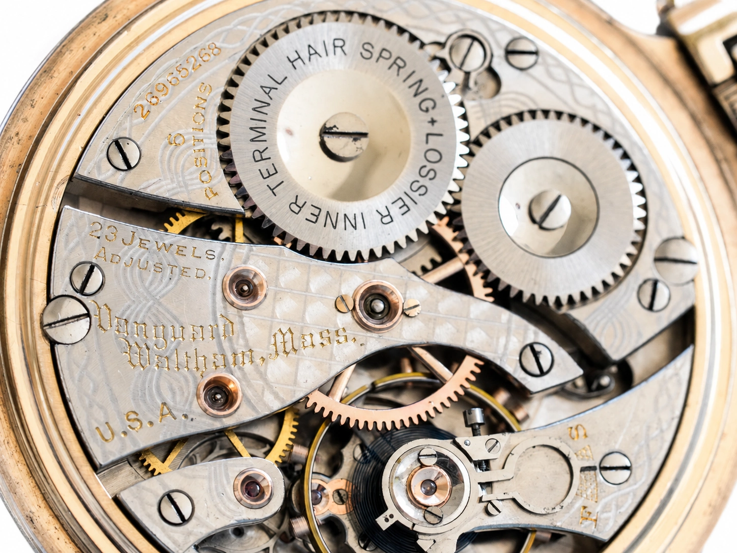 Open pocket watch movement showing terminal hairspring, jeweled lever escapement, and Waltham hallmark on plate.