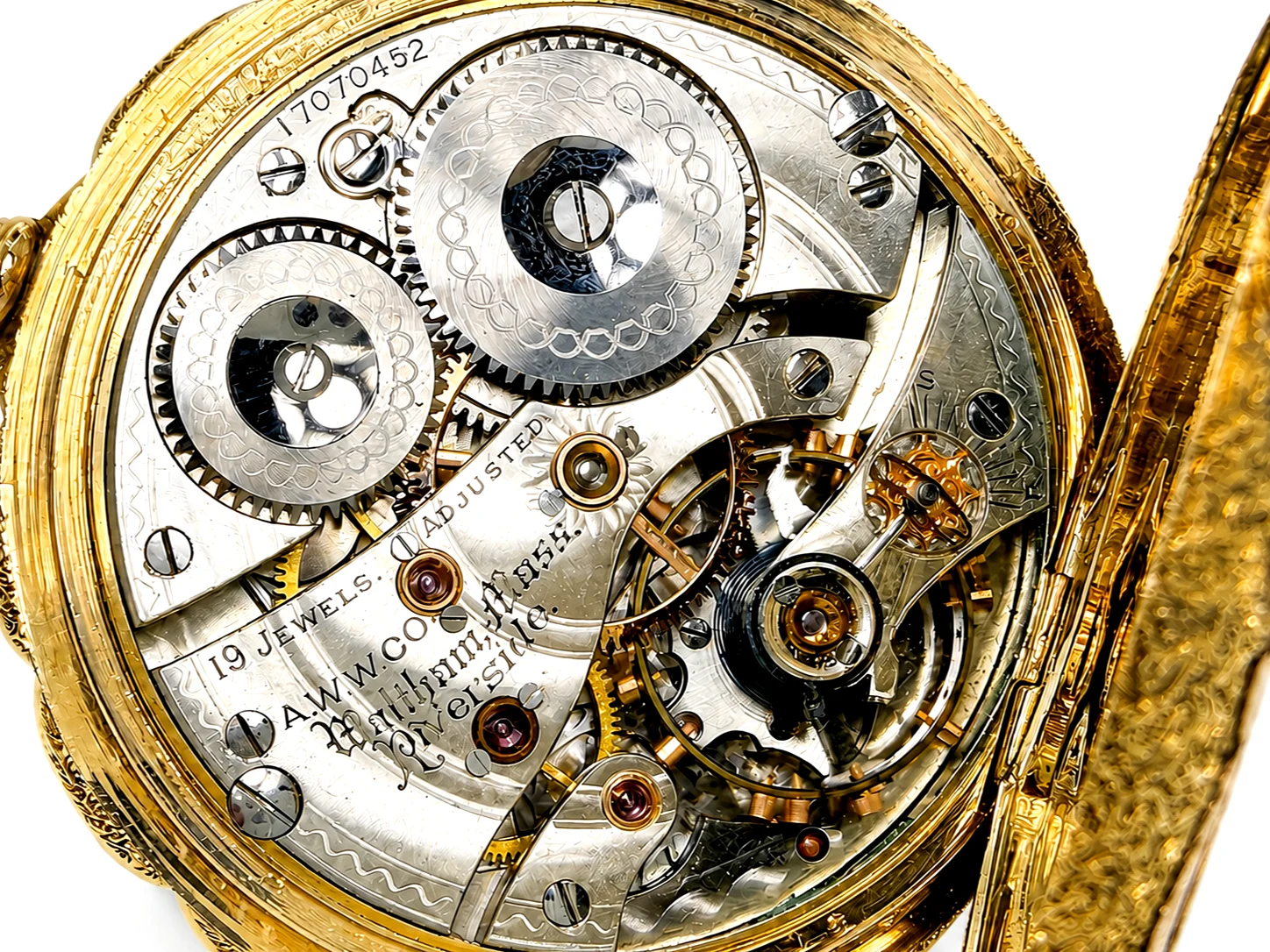 Open movement of pocket watch showing elaborate gear train with jeweled bearings and decorated balance wheel.
