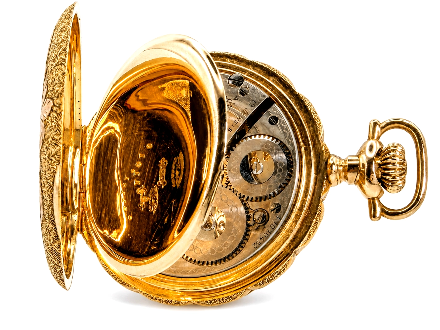 Gold hunting case pocket watch open to reveal engraved interior and mechanical movement with visible gears.