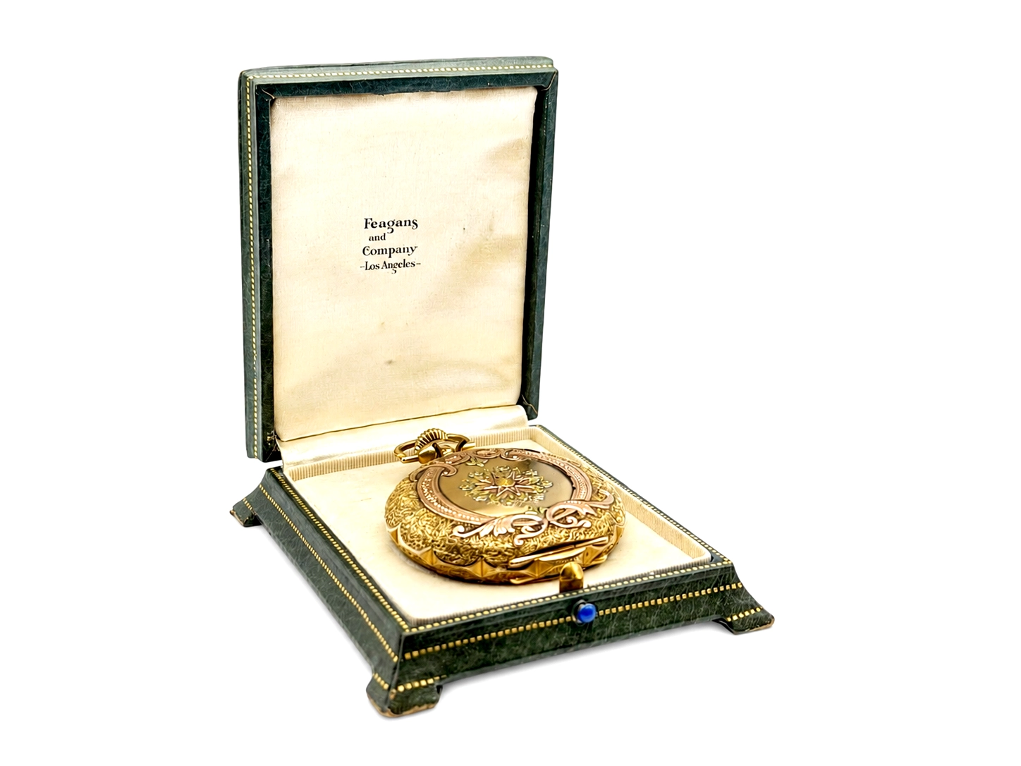 Gold ornate pocket watch in open leather presentation box labeled Reagans and Company, Los Angeles.